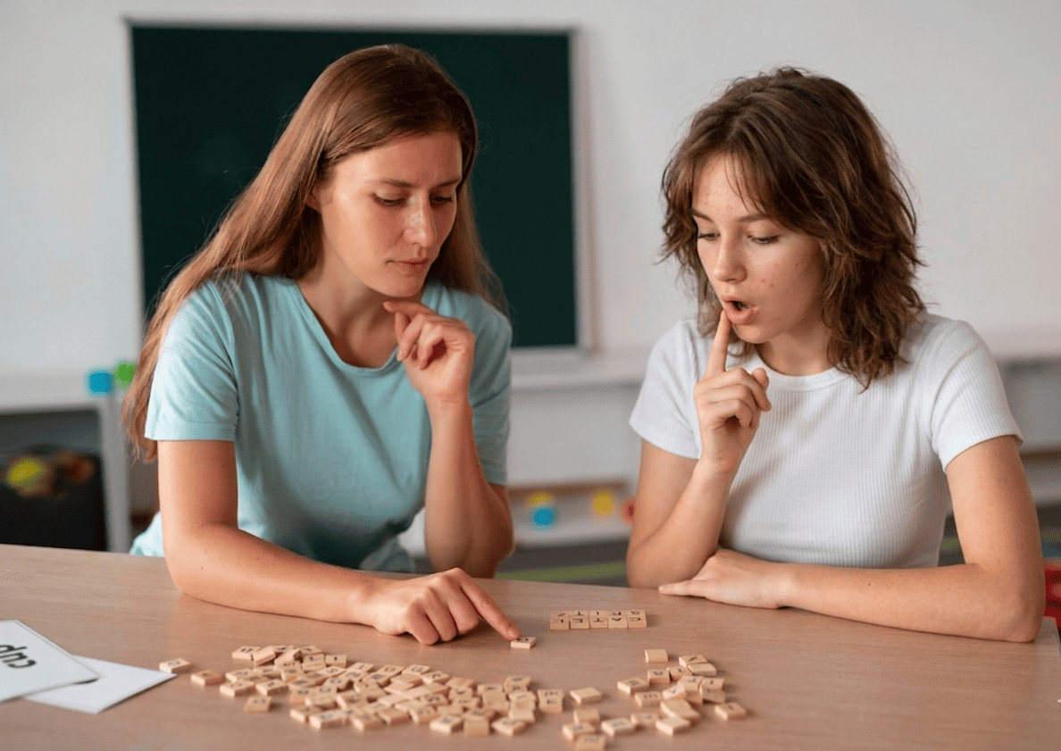Child playing r sound articulation bingo game with picture cards and speech therapist